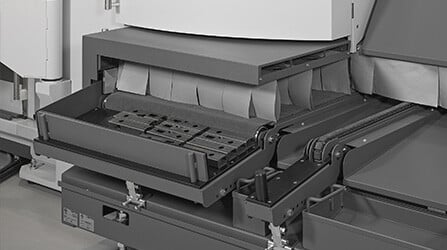Collection benches are equipped with motorized belts to unload finished parts.